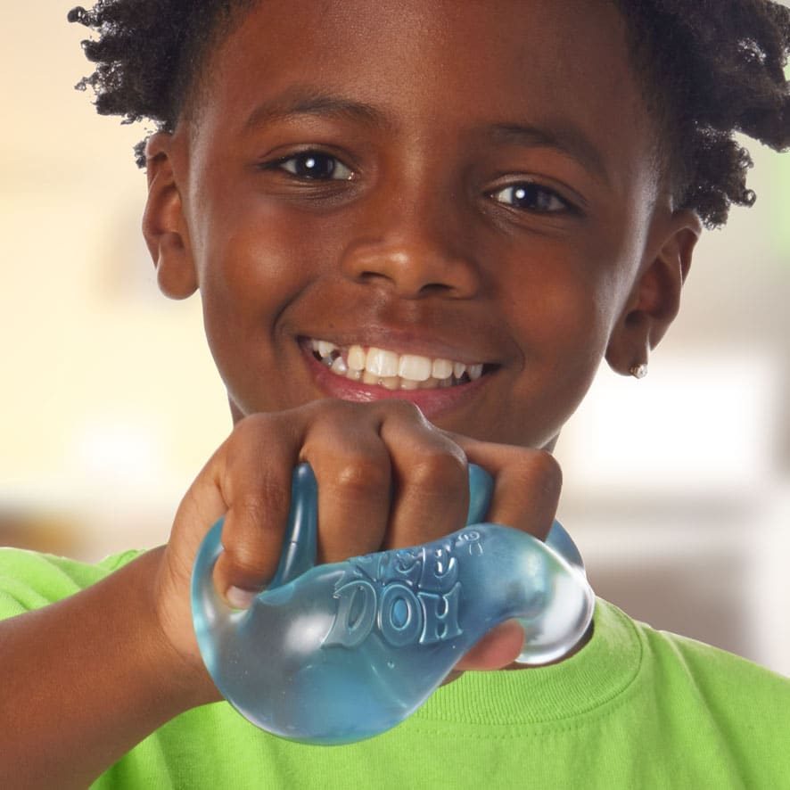 Boy squeezing a clear NeeDoh glob